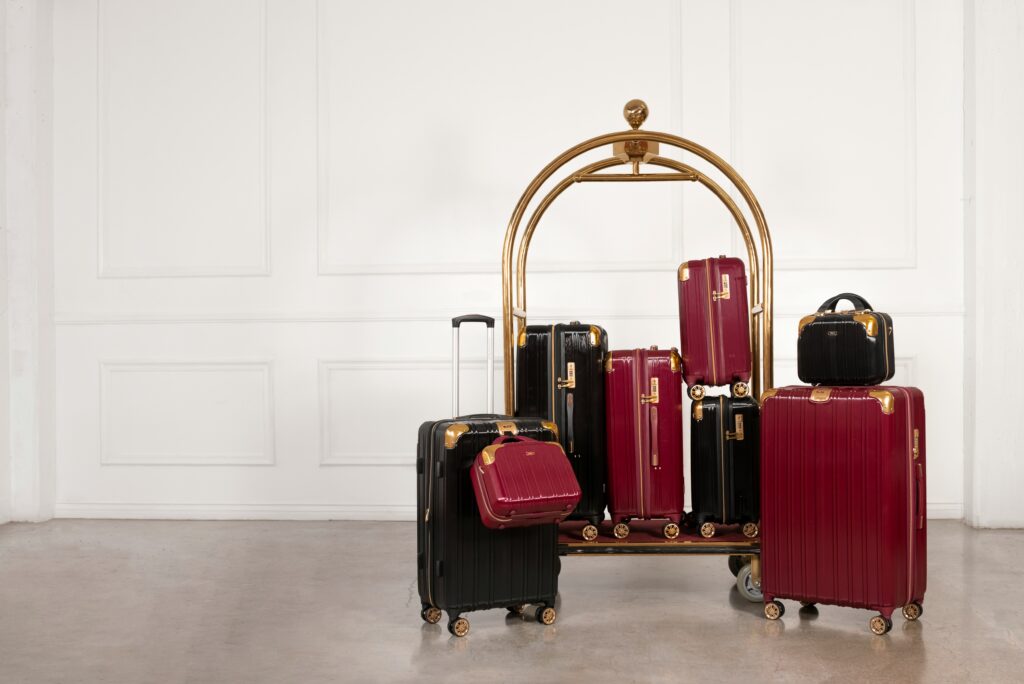 Black and red holiday travel suitcases sitting next to each other (travel tips).