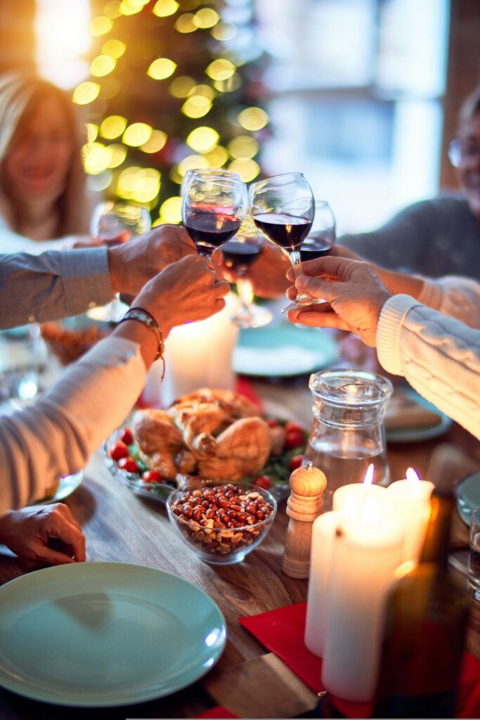 Table of holiday food, snacks, candles and wine (travel tips).