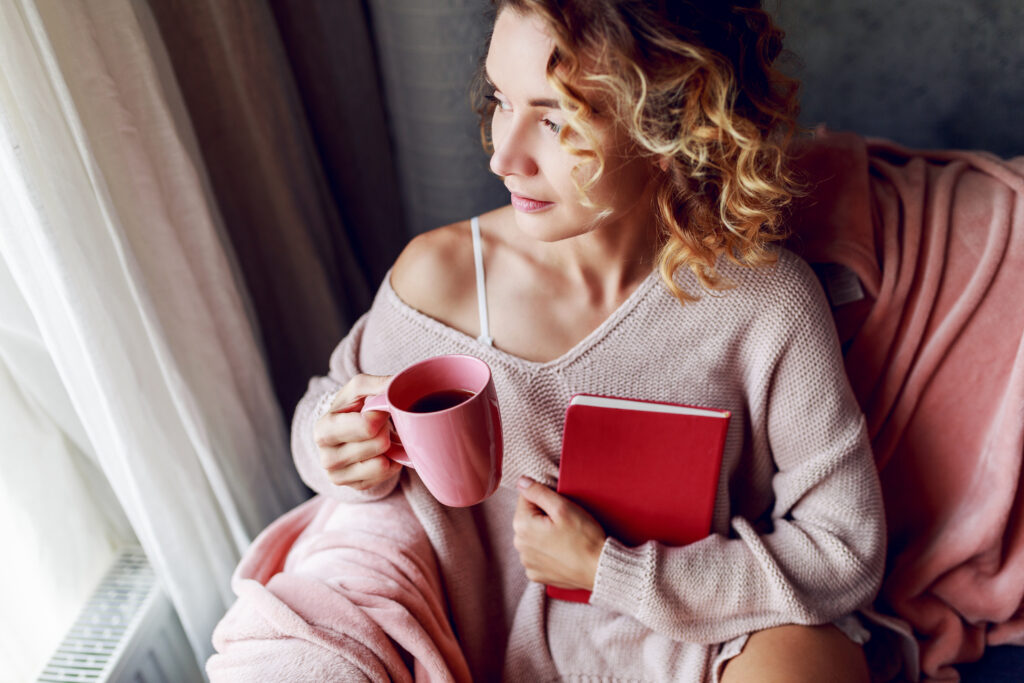 Woman setting priorities while drinking her morning coffee