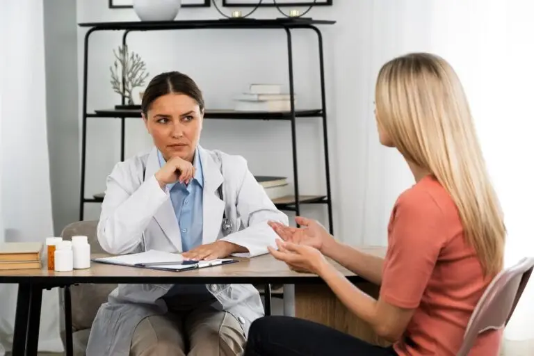 Woman listing her symptoms during doctor's visit