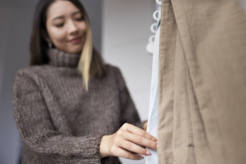 Woman picking out clothes for tomorrow to save time and simplify her life