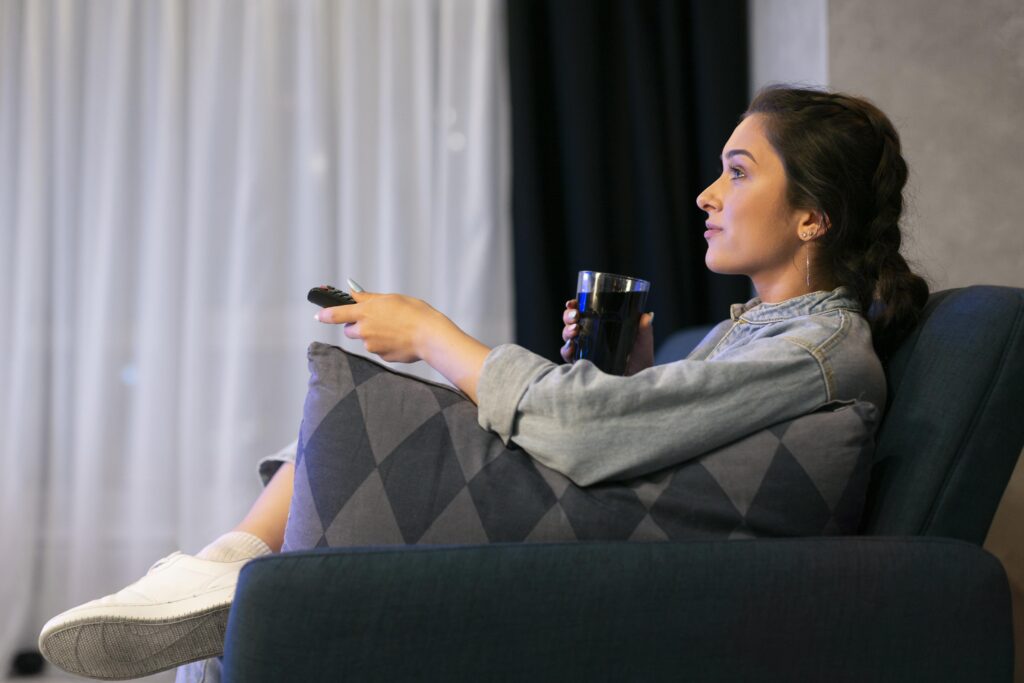 woman bookending her day by watching tv