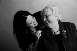 Mother’s Day image of a granddaughter and grandmother smiling together, perfect for blog posts about family bonding or gift ideas for grandma.