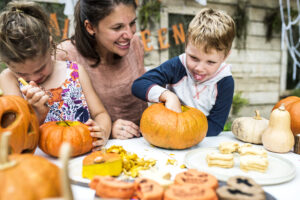 A family doing one of the pumpkin decorating ideas they found.