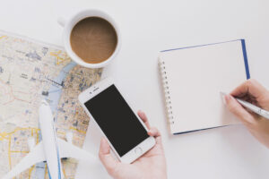 A person planning a trip using their phone trying to keep organized