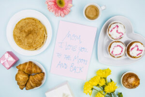 Mother's Day Brunch items including pancakes, muffin, coffee, and a note to mom
